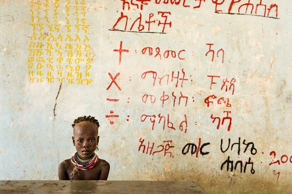 A Young Kara Girl in a School House, Dus Village by John Rowe