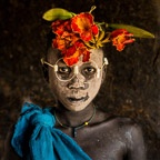 Portrait of a Suri Boy Adorned with Flowers and "Glasses"
