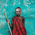 Portrait of a Suri Boy Against a Green Wall