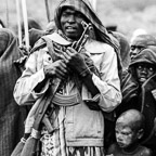 A Suri Man Watches a Donga Fight in the Rain