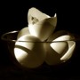 3 eggs and 1 shell in glass bowl front