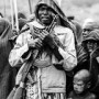 A Suri Man Watches a Donga Fight in the Rain